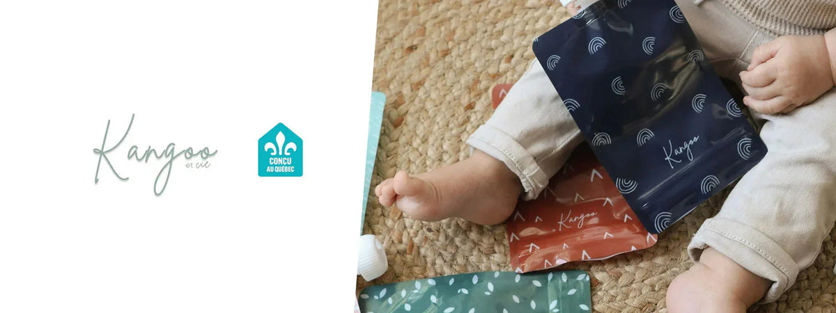 Baby sitting on a woven mat with reusable baby food pouches in colorful patterns