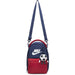 Nike kids' navy and red crossbody bag with soccer ball keychain, shown against a white background.