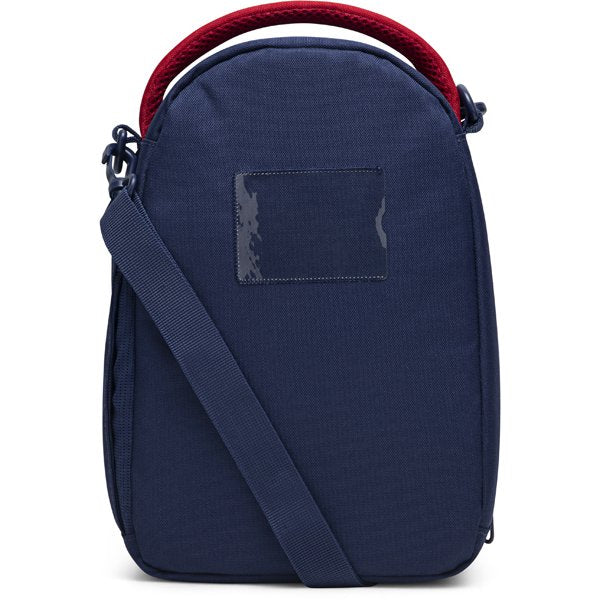 Navy blue insulated lunch bag with adjustable strap and red handle shown upright on a white background.