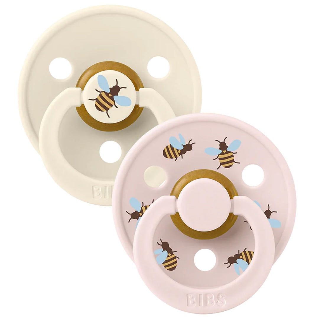 Set of two baby pacifiers in light pink and ivory with cute bumblebee designs