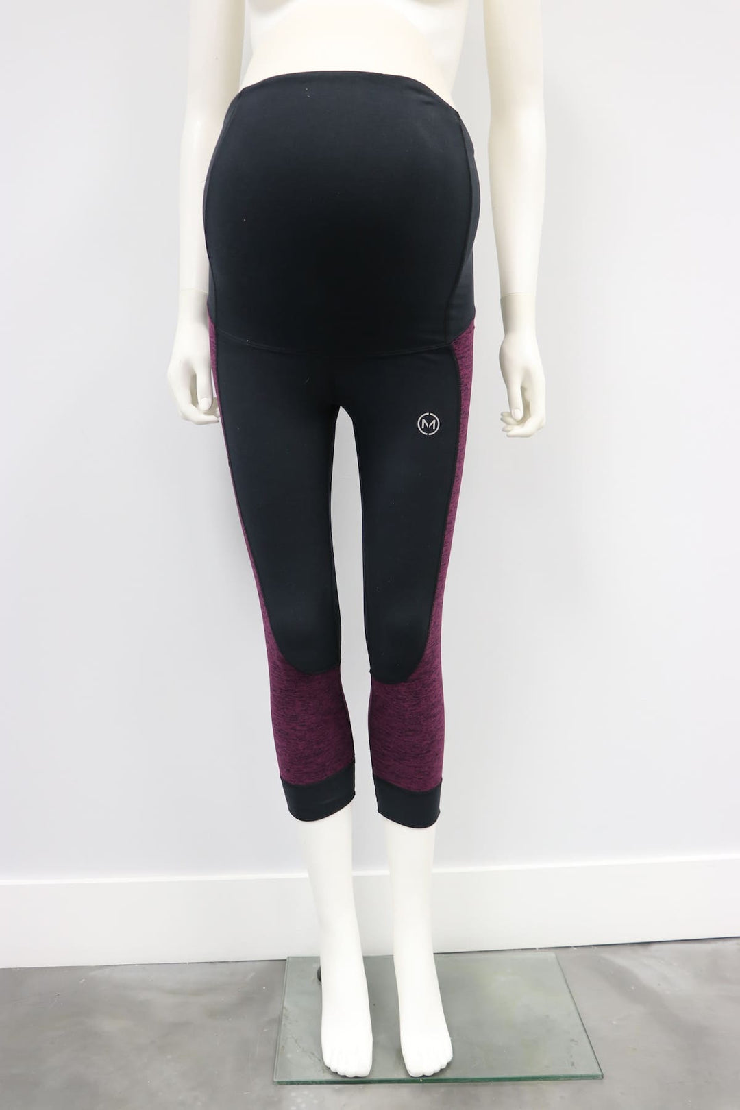 121701 Flex Legging Raisin Black maternity leggings displayed on a white mannequin against a plain wall.