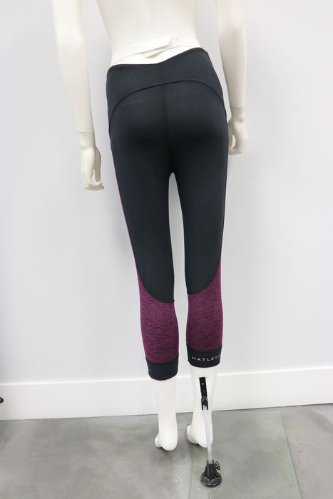 Flex Legging Raisin-Black shown on a mannequin, featuring black and purple color block design.