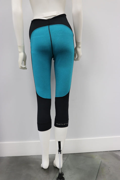 Matletik Flex Legging teal and black shown on mannequin, rear view against white background.