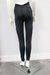 Courage Legging Black shown on mannequin, back view, with mesh panel details in a studio setting.
