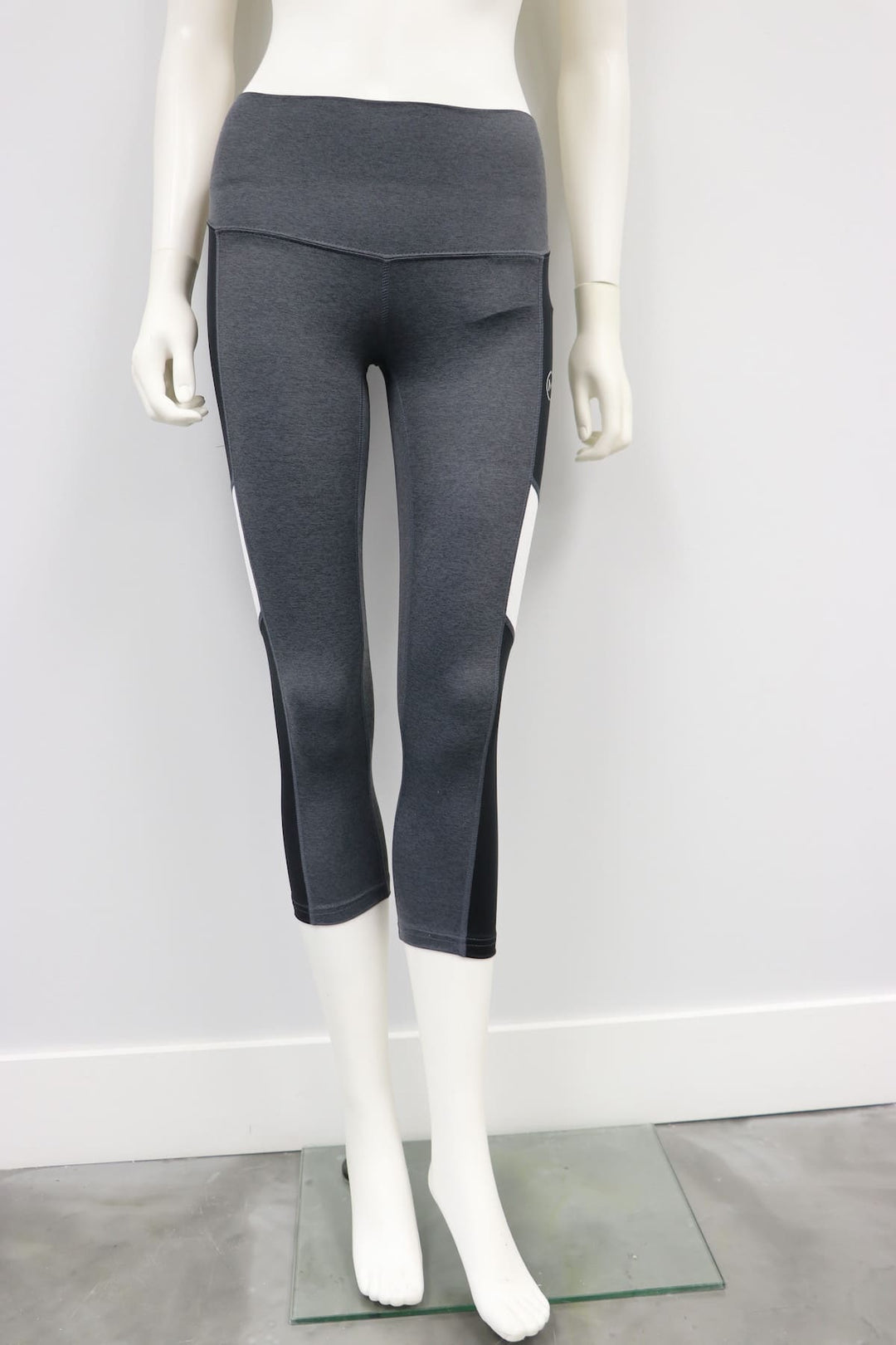 Esprit grey leggings with black and white side panels displayed on a mannequin against a white wall.