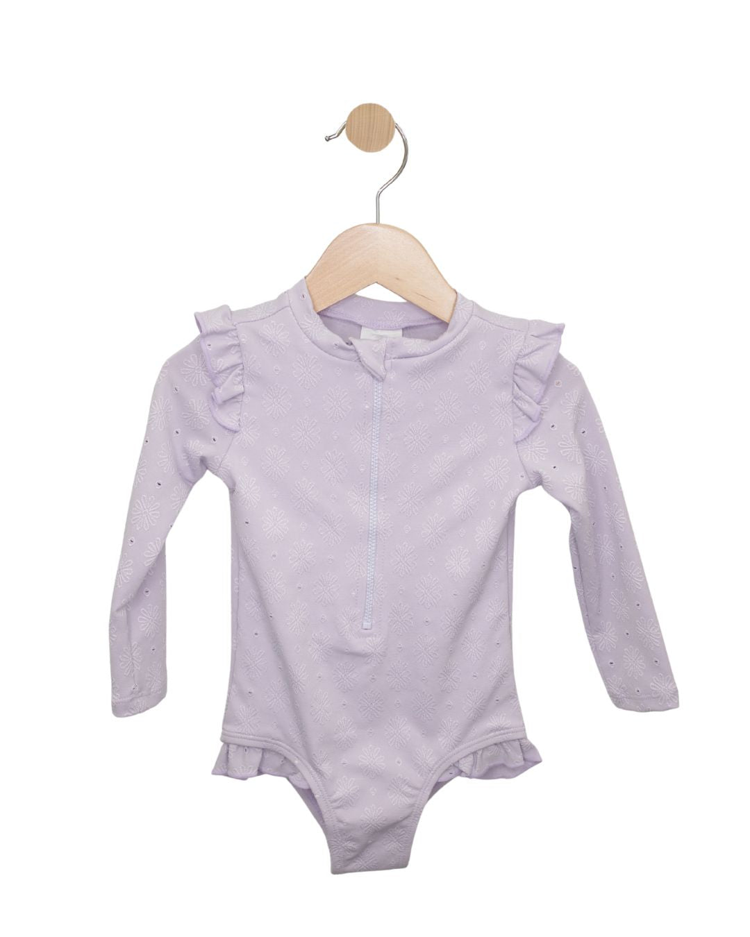 Light purple baby long sleeve ruffle bodysuit with zipper detail shown on a wooden hanger.