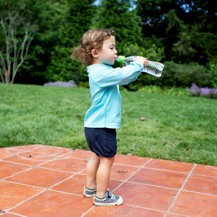 Spout Adapter A-5 attached to water bottle, held by toddler outdoors on a patio.