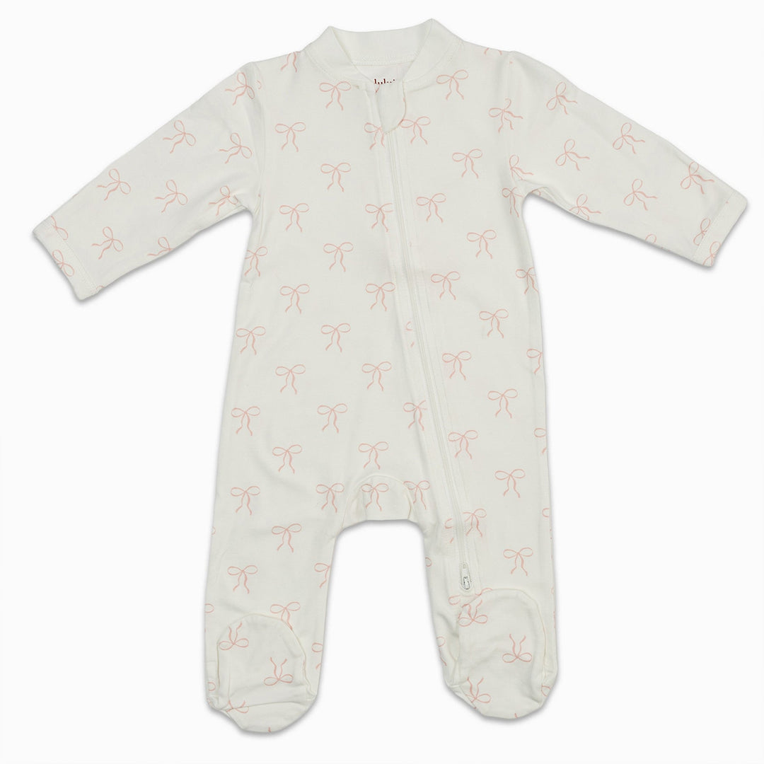 White baby sleeper with pink bow print and front zipper, long sleeves and footed design