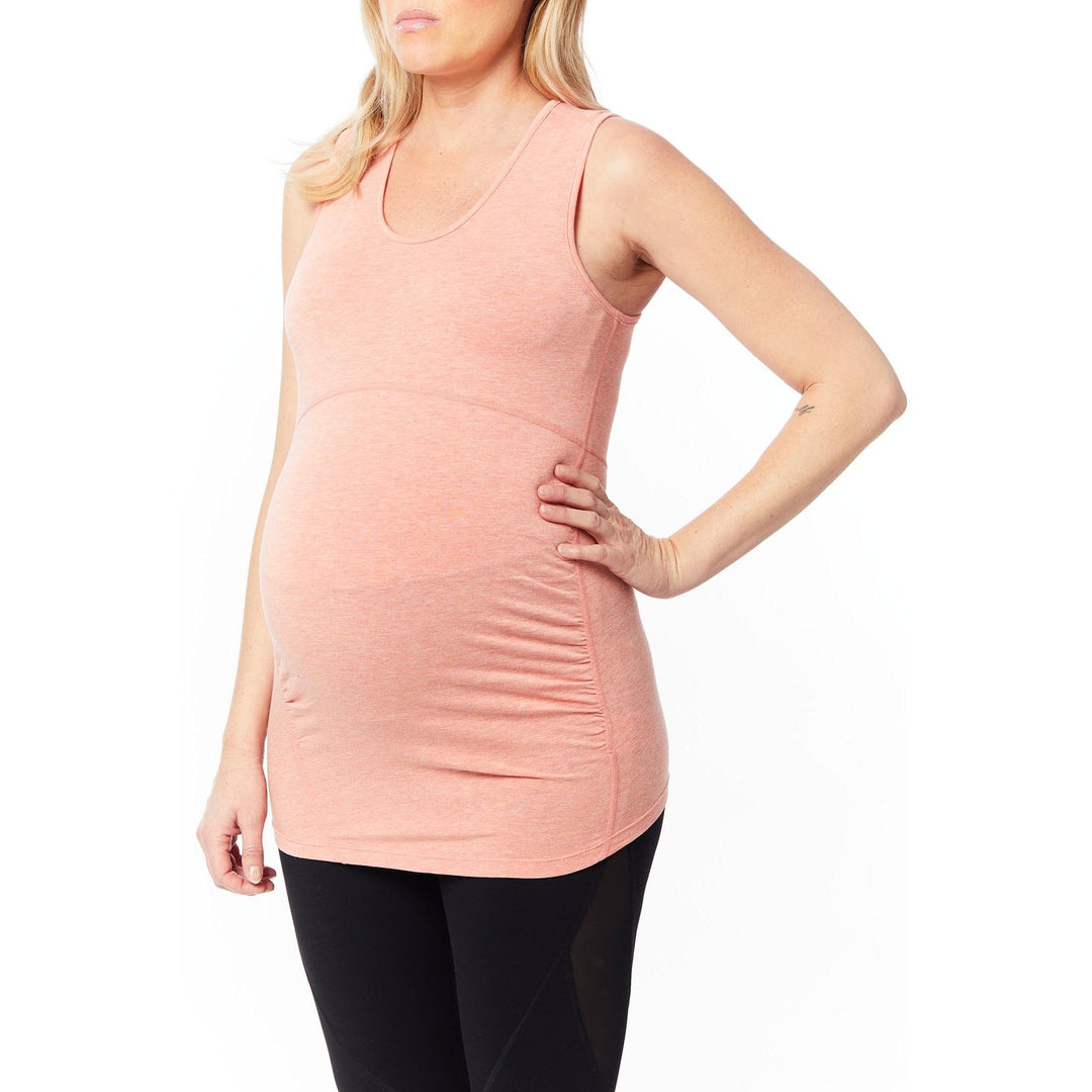 Coral maternity tank top shown on a pregnant woman standing against a white background.