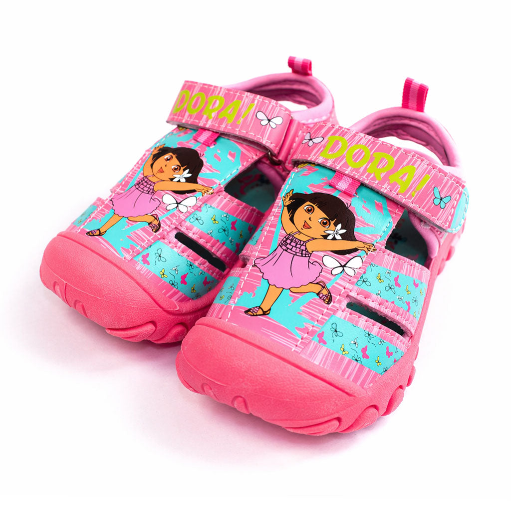 Girls Dora closed toe sandals in pink with cartoon character print, shown on a white background.