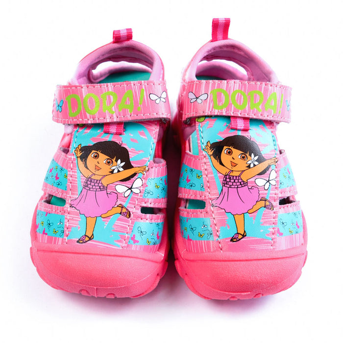 Girls Dora closed-toe sandals in pink and blue, shown upright with cartoon graphics and butterfly prints.