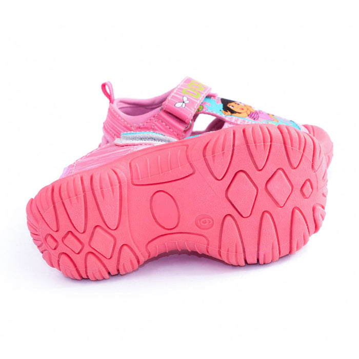 Girls' Dora closed toe sandal in pink, shown with textured sole facing up on a white background.