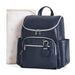 Navy blue diaper backpack with silver zippers and side pockets, paired with a soft changing pad.