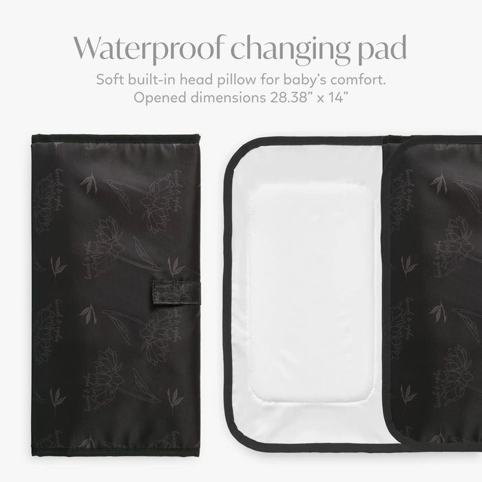 Black waterproof baby changing pad with floral pattern, shown folded and open with soft head pillow