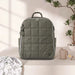 Quilted olive green diaper backpack with baby bottle, pacifier, and blanket on a table