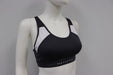 Matletik charcoal and white sports bra top displayed on a mannequin against a plain background.