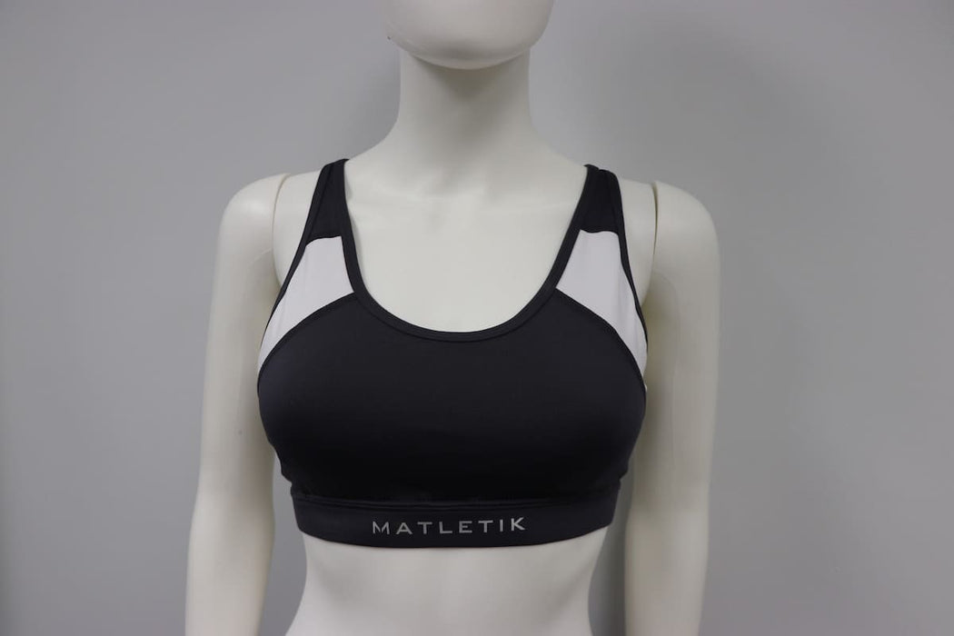 Matletik charcoal and white sports bra displayed on a mannequin against a plain background.
