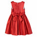 Red party dress for girls displayed flat, featuring a large bow and sleeveless design.
