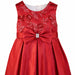 Red party dress for girls with sequin floral bodice and large satin bow shown on white background.