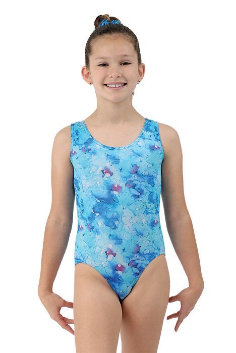 Girl wearing a blue marbled gymnastics leotard, standing and smiling against a white background.
