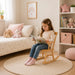 Economy solid maple wooden rocking chair for kids - Little girl on the rocking chair in her room reading a book