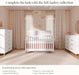 Modern nursery with white convertible crib, tall and double dressers, soft pink decor, and large windows.