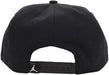 Black adjustable snapback cap shown from the back with a white logo on the closure.