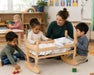 Solid maple wooden doll cradle - children  playing with the cradle at daycare