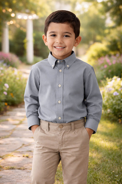 Elevate Oxford Shirt in grey worn by a child standing outdoors on a garden path.