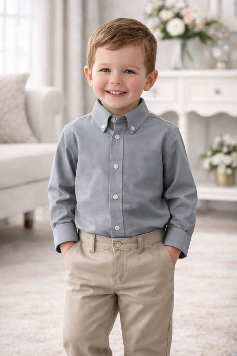 Elevate Oxford Shirt in grey shown on a young boy standing in a bright, elegant living room.