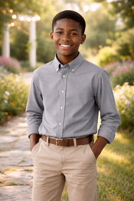 Elevate Oxford Shirt in grey worn by a boy standing outdoors on a garden path.