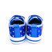 Paw Patrol boys canvas shoes shown from the back, blue with white paw and tool prints.