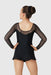 Girl’s black long sleeve mesh skating dress shown from the back against a plain background.