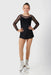 Girls' black long sleeve figure skating dress with mesh sleeves, shown worn with white skates on a white background.