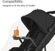 Black stroller with canopy, snack tray, orange sippy cup, and snack, designed for Minu V3