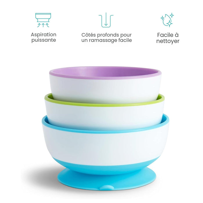 Stacked suction baby bowls in white with blue, green, and purple rims, shown on a white background.