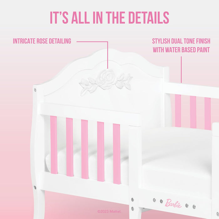 White and pink baby crib with rose detailing and dual-tone finish, ideal nursery furniture