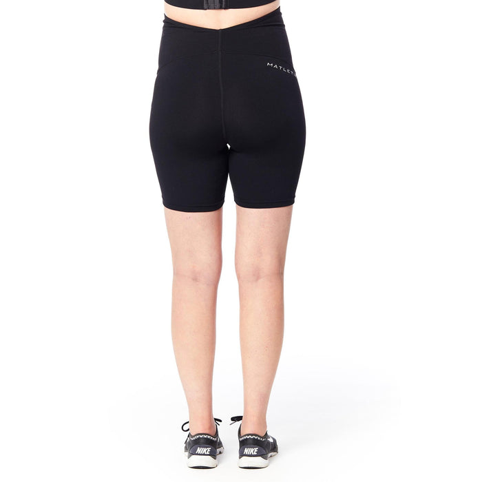 Matletik black maternity bike shorts shown from the back on a standing person.