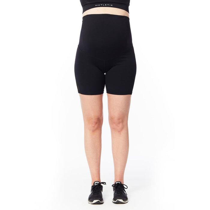Matletik black maternity bike shorts shown on a standing pregnant woman against a white background.