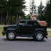 Kids electric ride-on SUV car toy shown outdoors with two children riding on a paved path.
