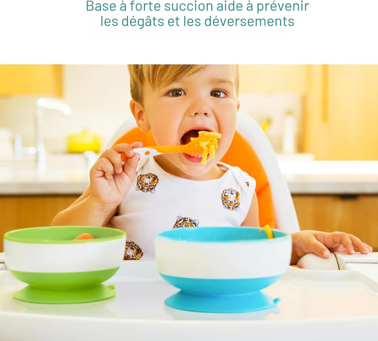Toddler using silicone suction bowl and spoon set while eating in a high chair.