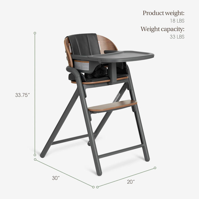 Modern baby high chair with wood accents, black seat, and tray, shown with dimensions.