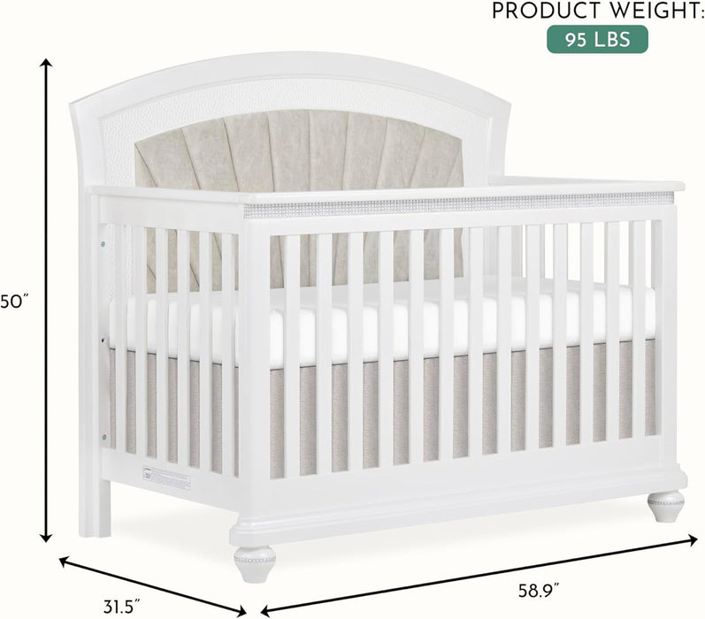 White wooden baby crib with upholstered headboard, slatted sides, and size dimensions shown
