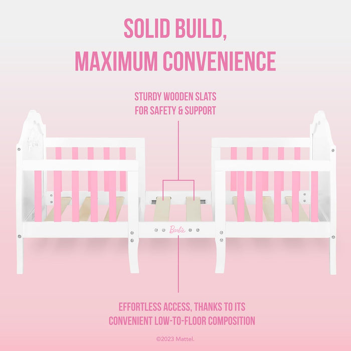 White and pink wooden doll bed with sturdy slats, low-to-floor design for easy access.