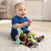 Baby play toy with teether and plush animal features, shown with baby on soft mat indoors.