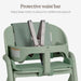 Green baby high chair with safety harness and protective waist bar for secure seating