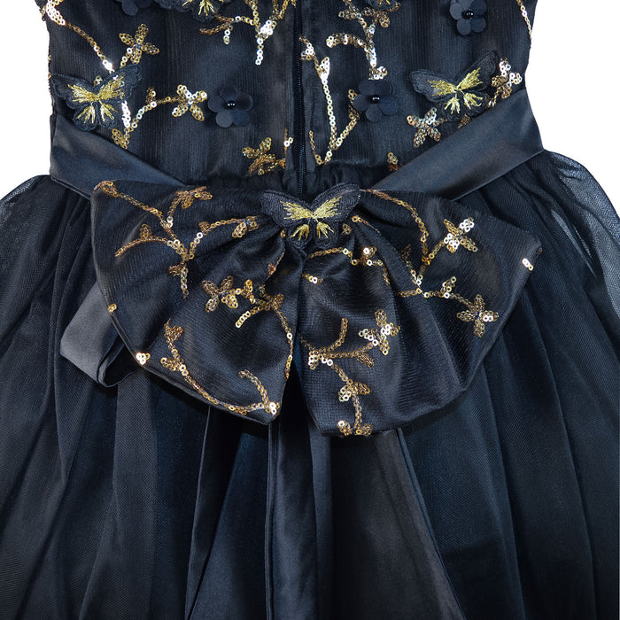 Black glitter dress with large bow and gold sequin floral embroidery, shown close up.