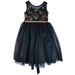 Bow Glitter Dress Black shown on white background with gold floral embroidery and tulle skirt.