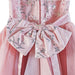 Girls' glitter dress with sequin bow, floral and butterfly embroidery in a close-up view.