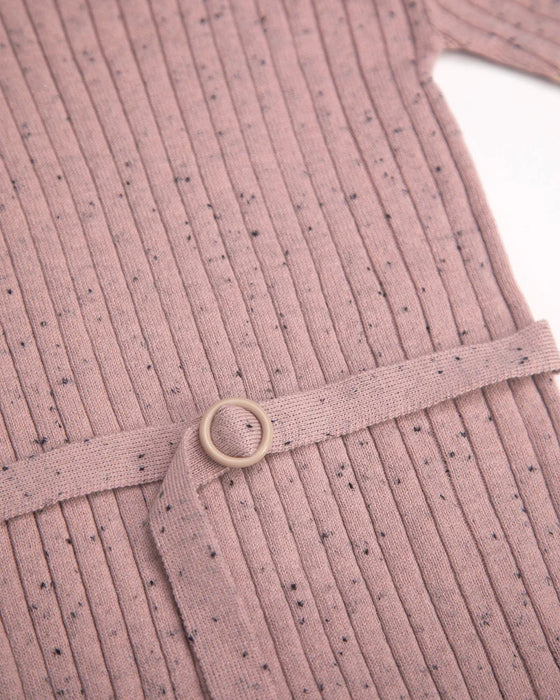 7AM Hug Me ribbed knit dress in ash rose, close-up of fabric texture and belt detail on flat surface.